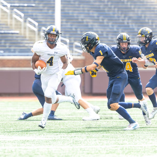 Dewitt's Blake Haller looks to elude Haslett's D'Angelo Fitzpatrick during the first half Thursday, Aug. 25, 2022, at the Battle of the Big House in Ann Arbor.