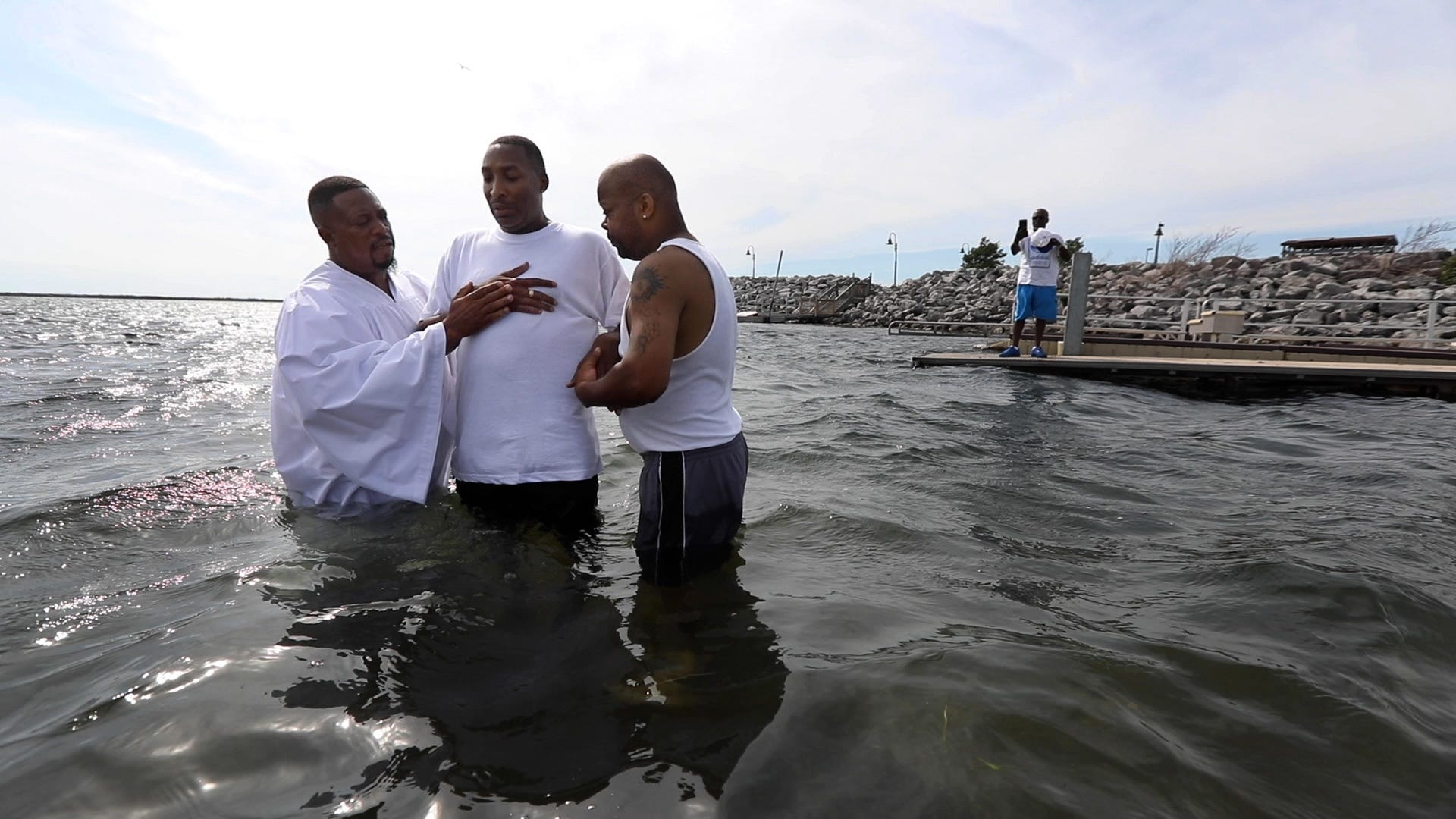 Pastor Kenneth Simmons of Cold Spring Bible Chapel, with help from church member Guy Capps, baptizes Lee Lemon in Lake Erie at Buffalo Harbor State Park in Buffalo, N.Y., on Saturday, July 23, 2022. The church holds a baptism after their annual picnic.