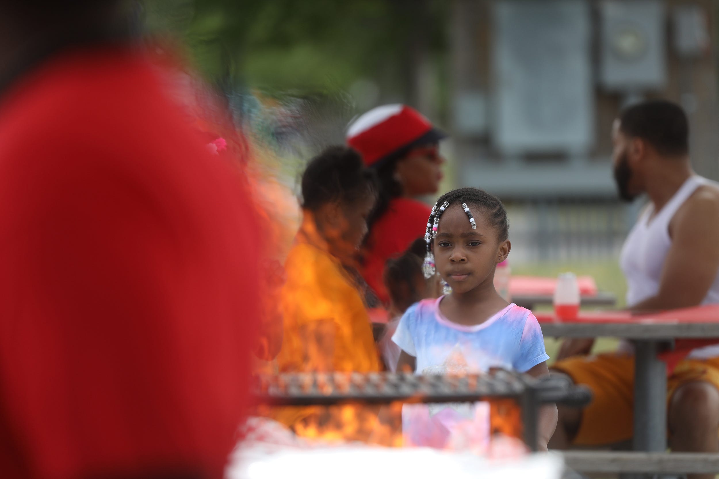 A child watches the flames that were just lit on the grill at a pavilion at Buffalo Harbor State Park on Lake Erie in Buffalo, NY on Saturday, July 23, 2022.  Cold Spring Bible Chapel held their annual family picnic that ended with members and anyone else who felt the calling to get baptized.