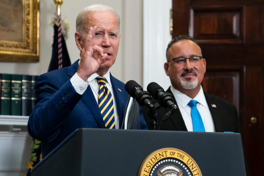 President Joe Biden responds to a question about the FBI search of former President Donald Trump's Mar-a-Lago estate Wednesday, Aug. 24, 2022, in the Roosevelt Room of the White House in Washington. Education Secretary Miguel Cardona listens at right.