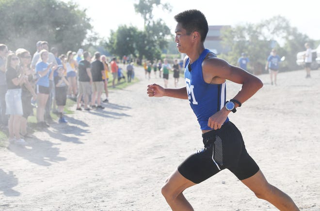 Collins-Maxwell's Ethan Haus takes a lead during Collins-Maxwell Cross Country Invitational at Center Grove Orchard on Thursday, August 25, 2022, in Cambridge, Iowa.
