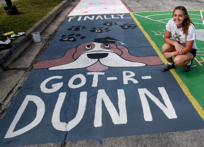 Jefferson High School senior Rylee Dunn, 16, painted her Bassett Hound, named Gunner, with a message on the parking spot she chose at school. This is Dunn's reserved parking spot for the year. Recently, 30 seniors took part in buying a reserved parking spot for ten dollars. The money will go toward their prom.  Jefferson Public Schools start school Tuesday, August 30.