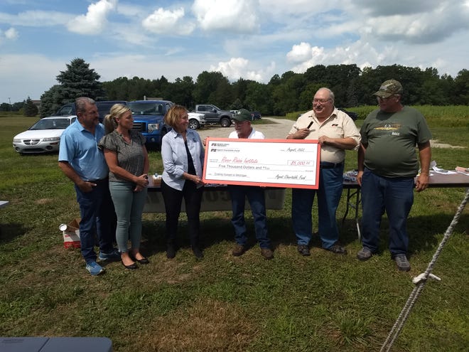 The Monroe County Farm Bureau and the Michigan Farm Bureau Insurance Agents Charitable Trust Foundation donate a check to the River Raisin Institute for $5,000.  The money will be used to grow more fruits and vegetables at the MCCC Student Ag Farm.  All produce is then donated to MCOP, the Village Market and The Center. Pictured here (left to right) are:  Mark and Sue Jarrait, representing the Farm Bureau Insurance Agents; Danielle Conroyd, Executive Director of RRI; Pete Loughney, an RRI Board member, and Roger Bezek, President of the Monroe County Farm Bureau and Ron Stadler, a Farm Bureau Board member.