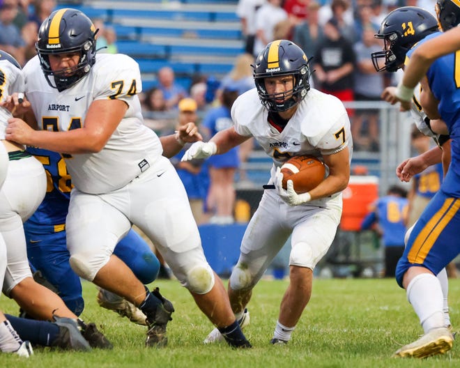 Airport junior Jack Mills (7) finds a hole behind teammate Chase Johnson (74) during the season opener at Ida on Thursday, August 25, 2022.