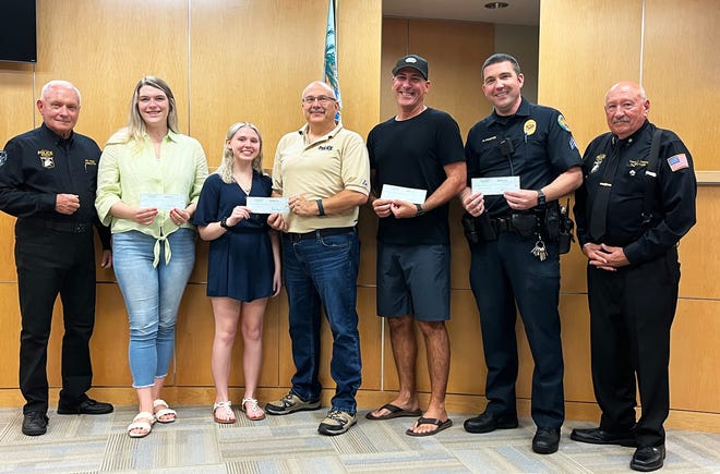 Marco Island police officers and students recently gathered to accept scholarship checks from the Marco Island Police Foundation. From right, MIPF Scholarship Chair Bill Miller, Meghan Brown, Davin with her father, retired Captain Dave Baer; Officer John Gray, Sergeant Mark Haueter and MIFP President Vernon Geberth.