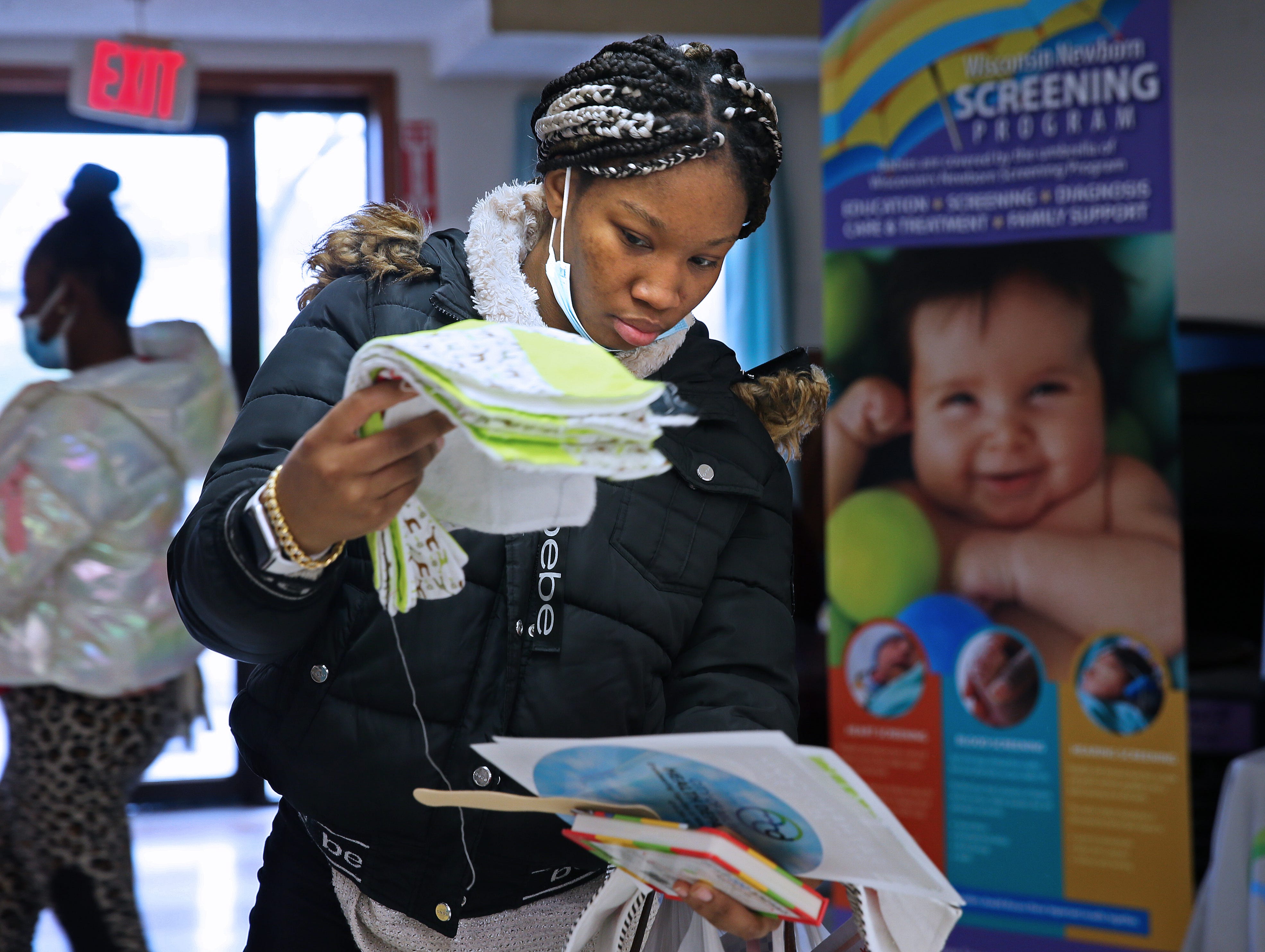LaShawnda Gray, six months pregnant, picks out baby items at the Blanket of Love baby shower at Ascension Ebenezer Health Resource Center.