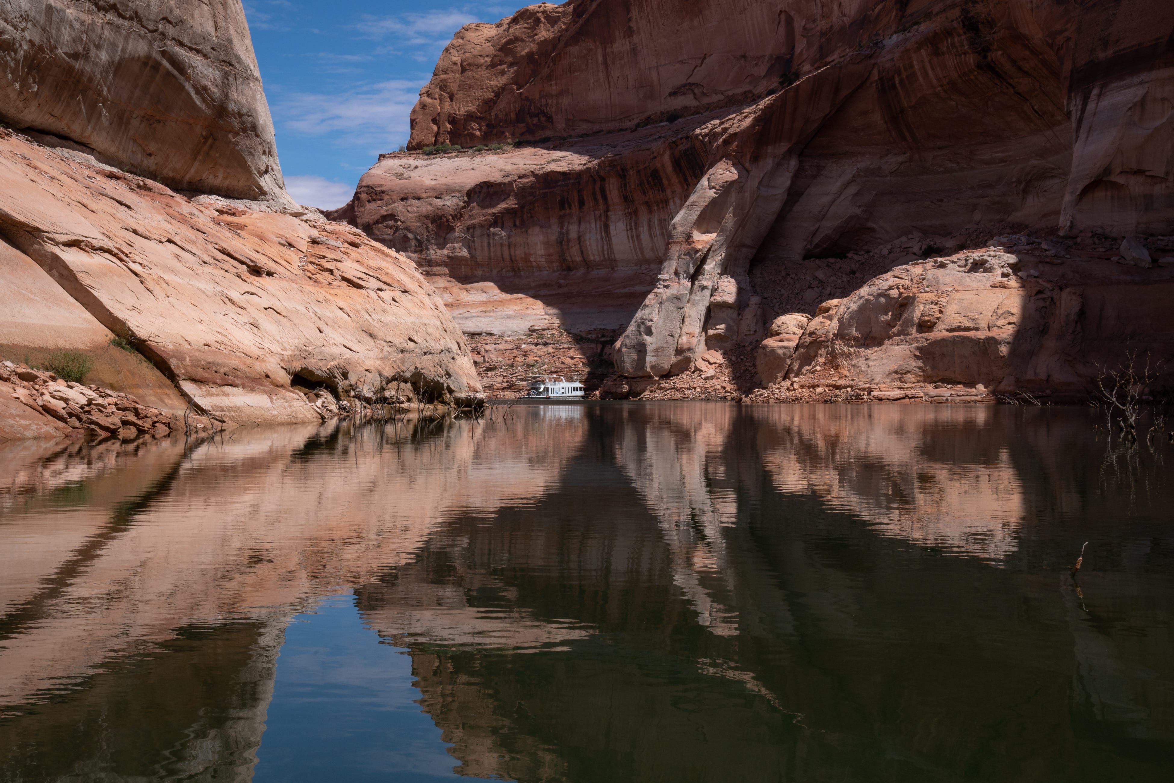 A houseboat is anchored on Clear Creek at Lake Powell on Aug. 16, 2022. The future of Lake Powell, including its recreation opportunities, is uncertain after years of decreasing water levels.