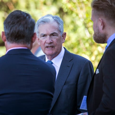 Federal Reserve Chair Jerome Powell, center, takes