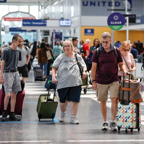 Travelers arrive at O'Hare International Airport o