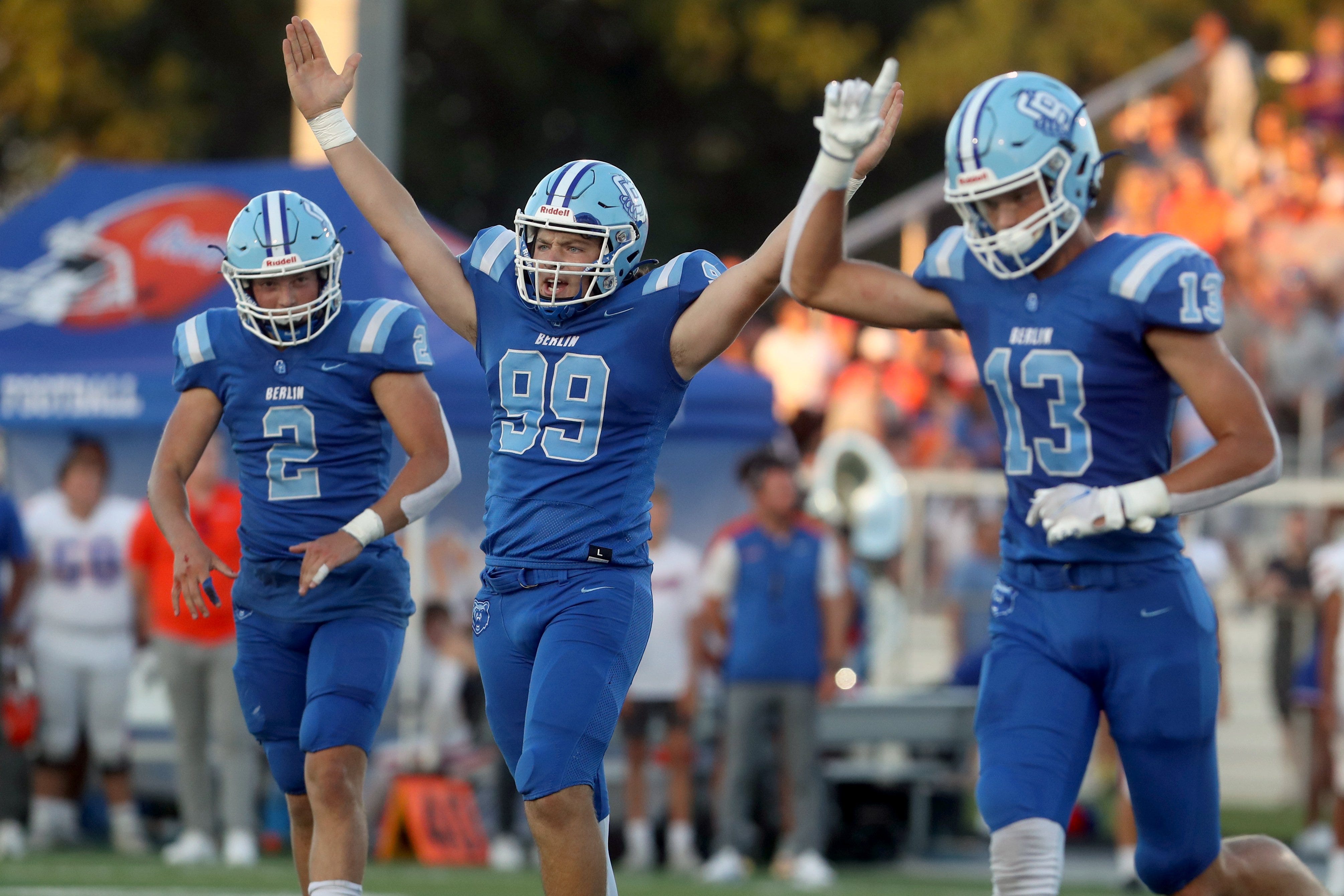 Olentangy Berlin's Spencer Conrad (99) celebrates with teammates Harrison Brewster (2) and Jared Moeller (13) after kicking a 49-yard field goal to end the half during a game against Olentangy Orange on Aug. 26 at Olentangy Berlin High School in Delaware.