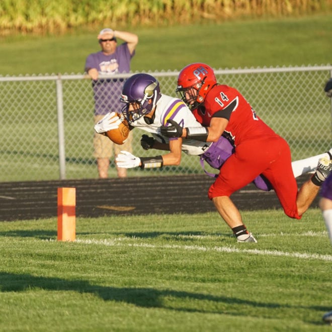 Bronson's Drew Norton (7) dives into the end zone for a touchdown Friday versus Prairie Heights. Norton hauled in the 15 yard catch from Boston Bucklin
