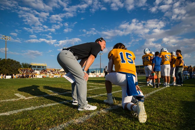 Lubbock Christian head coach Chris Softley talks with quarterback Bax Townsend (15) after the first touchdown of the game, Friday, Aug. 26, 2022, at Lena Stephens Field at Lubbock Christian High School.