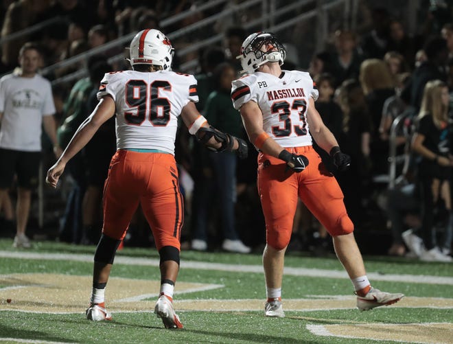 Massillon's Malachi Card (96) and Cody Fair (33) celebrate during a high school football game against GlenOak at Bob Commings Field on Friday, August 26, 2022.