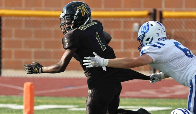 Taft ball carrier Rayshawn Holly (1) is tackled by Wyoming defender Coleman Jeffers (6) during the football game between Taft and Wyoming high schools  Friday, Aug. 26, 2022.