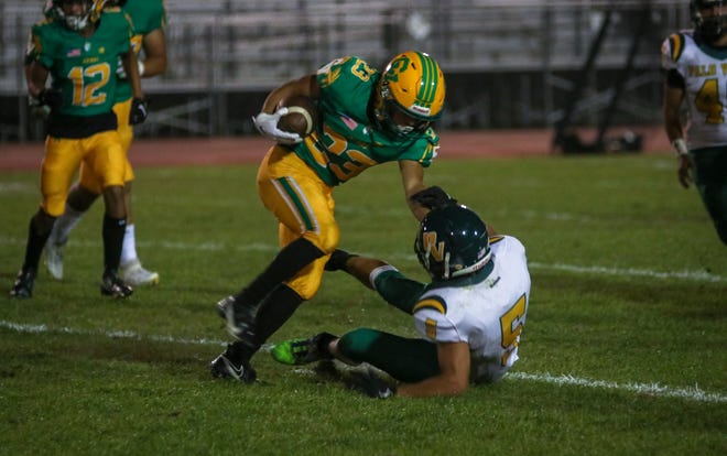 Coachella Valley's Aaron Ramirez (23) taking down Palo Verde defenders as he continues to run with the ball, August 26, 2022.