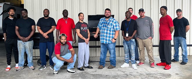 Twelve of the 14 work-release program inmates gather for a barbecue provided by Terrebonne Parish Sheriff Tim Soignet to honor their donation for children's school supplies, Aug. 20, 2022.