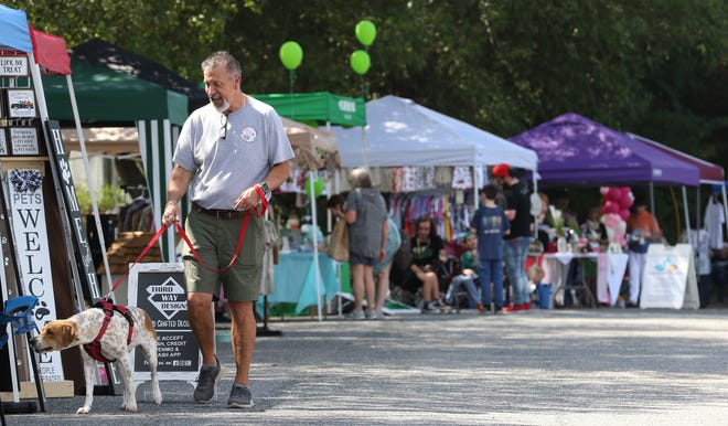 Paul Lowrence and Brooke check out the booths during the Clear the Shelter event held Saturday, August 27, 2022, at Gaston County Animal Care and Enforcement on Business Park Circle.