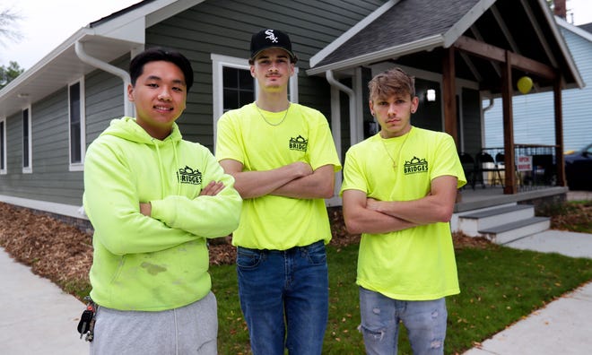 Students Ashton Xiong, Connor Vandelaarschot and Thomas Debeck are pictured Aug. 25, 2022, outside the house they helped build through the Green Bay School District's Bridges Construction and Renovation program in partnership with NeighborWorks Green Bay.