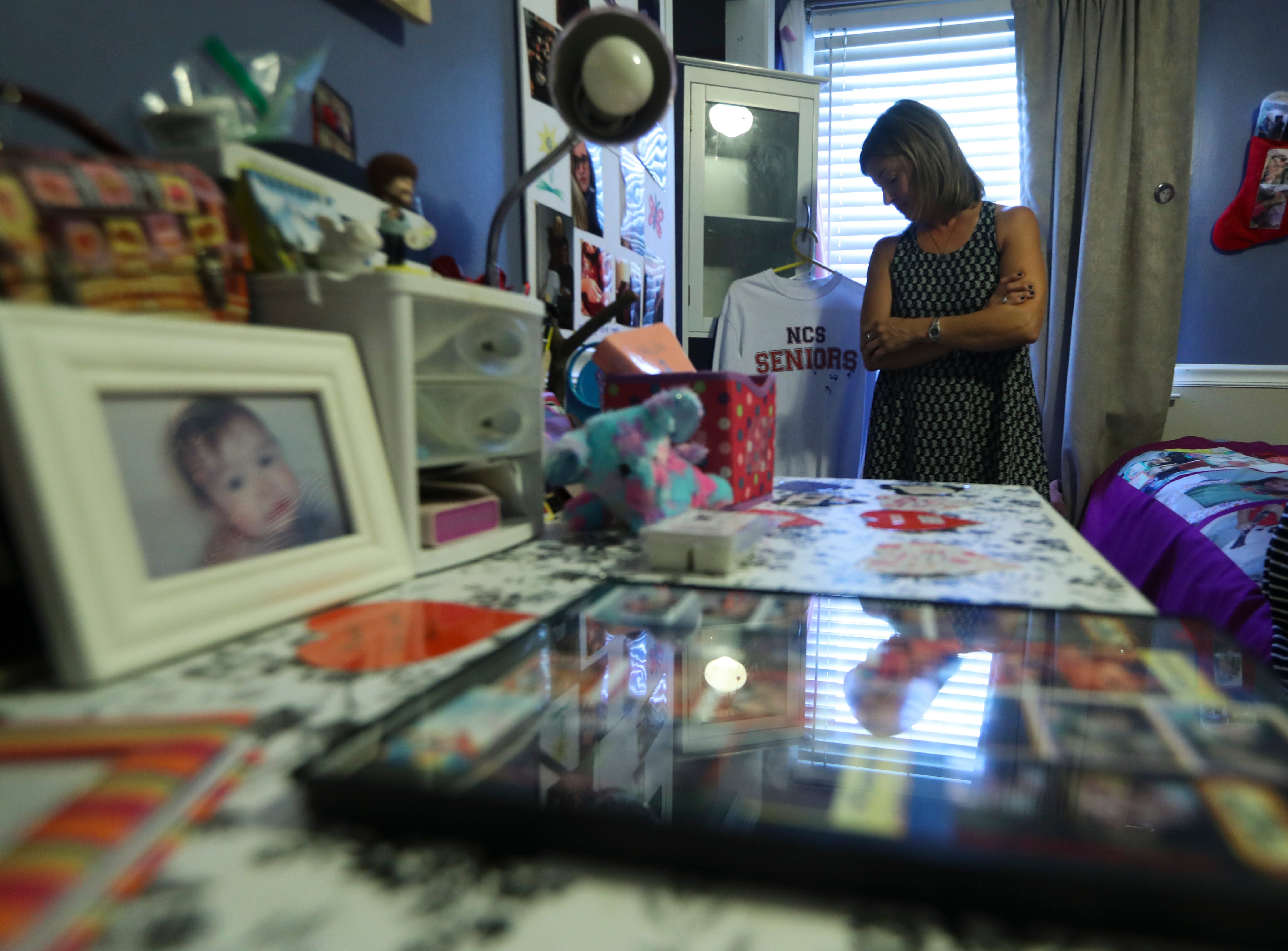 Heather Sparrow-Murphy looks over mementoes of her daughter, Madison Sparrow in Madison's bedroom.