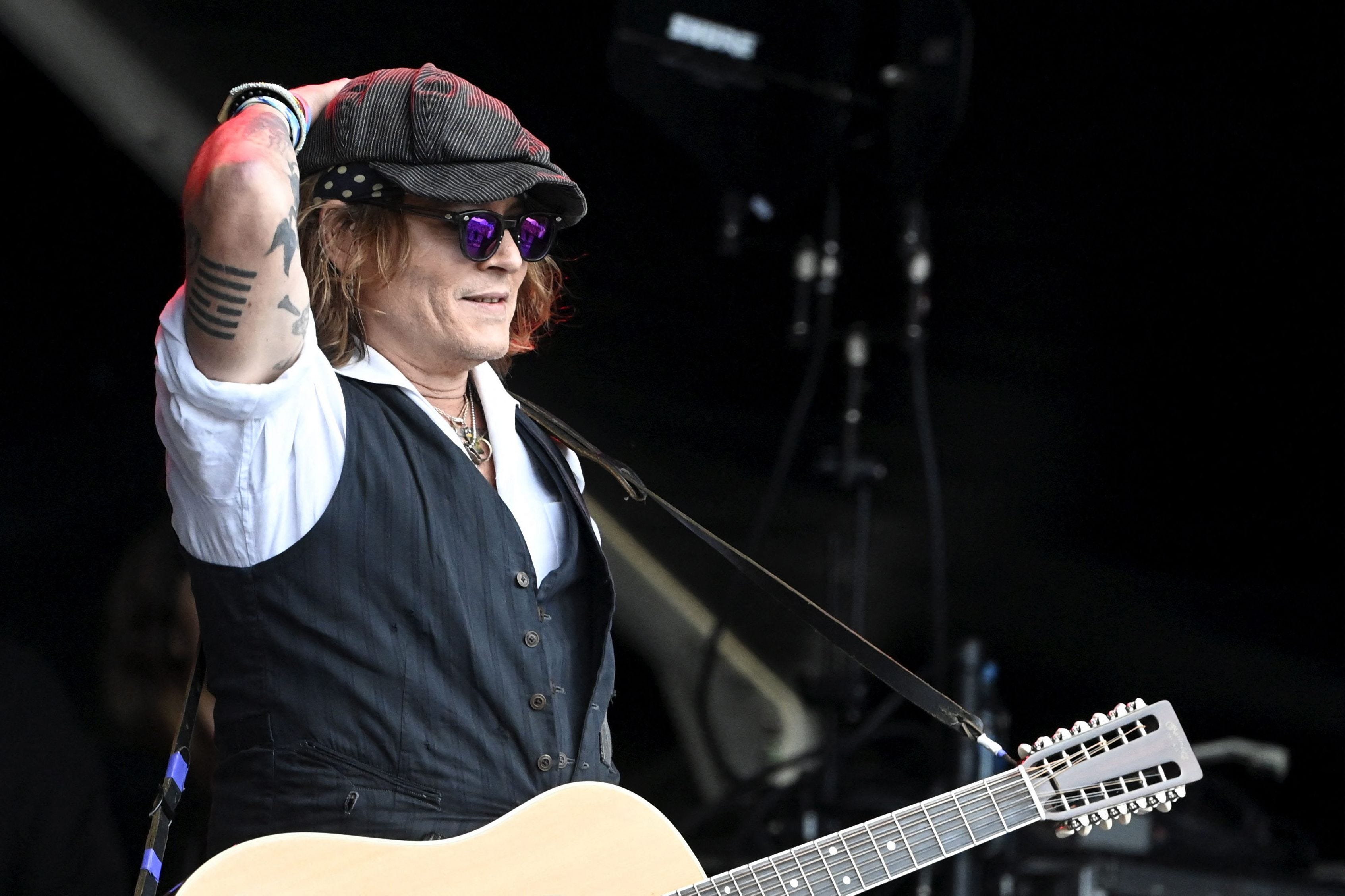 Johnny Depp performs on stage with Jeff Beck during the Helsinki Blues Festival in Helsinki on June, 19, 2022.