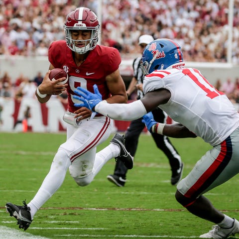 Alabama quarterback Bryce Young (9) is pushed out 