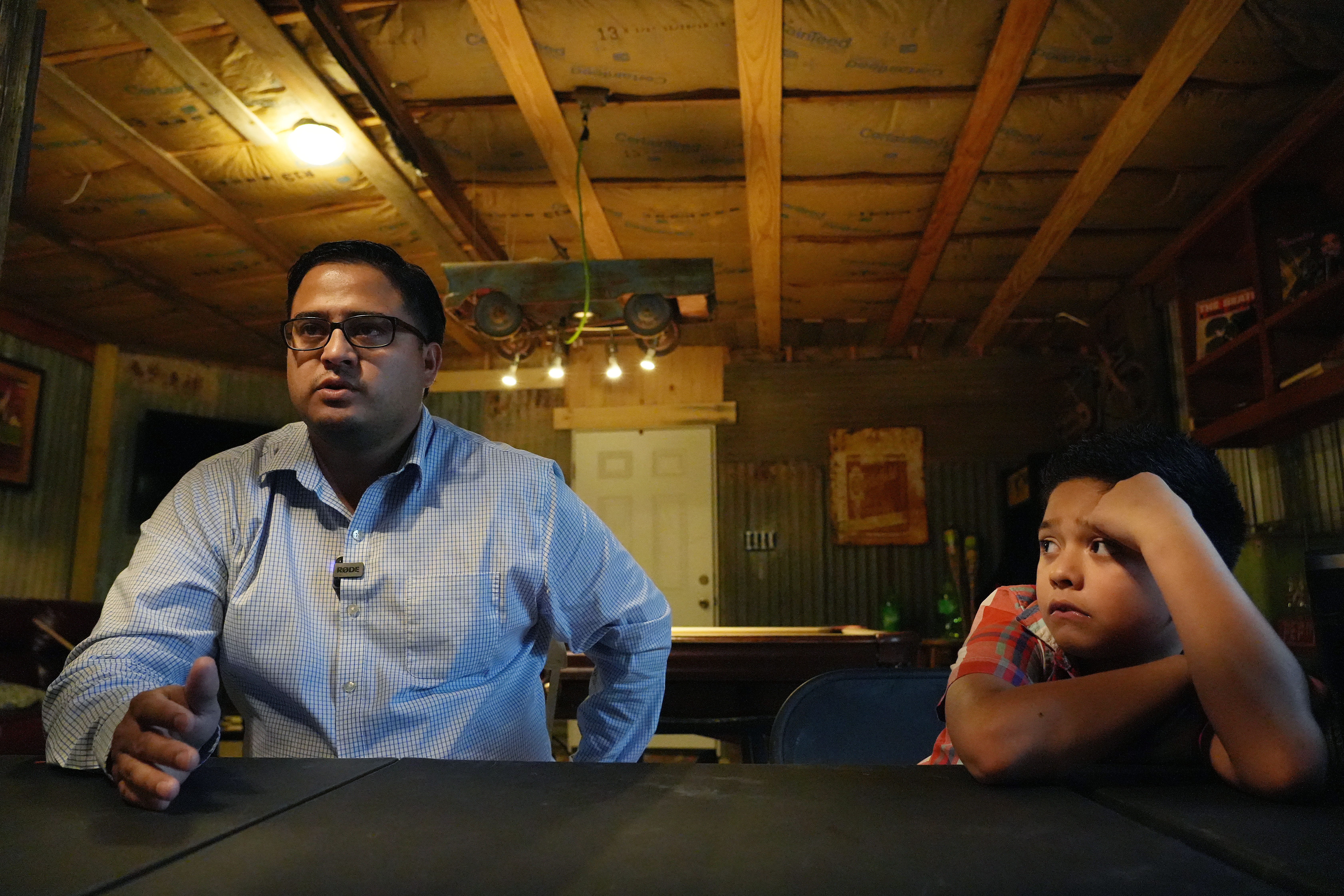 Adam Martinez and his son Zayon talk about Zayon's decision to be homeschooled this school year on Aug. 25 at their home in Uvalde. Martinez said he had found out recently that his son had no interest in going back to school in person after surviving the mass shooting at Robb Elementary. Martinez said he would not push his son to return.