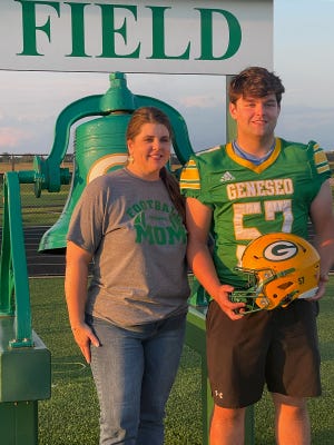 Geneseo senior Jordan Melchert and his Mom, Michelle Kotabbi, pose for a photo after they striped and decorated Jordan’s helmet at the team’s Helmet Striping Night.