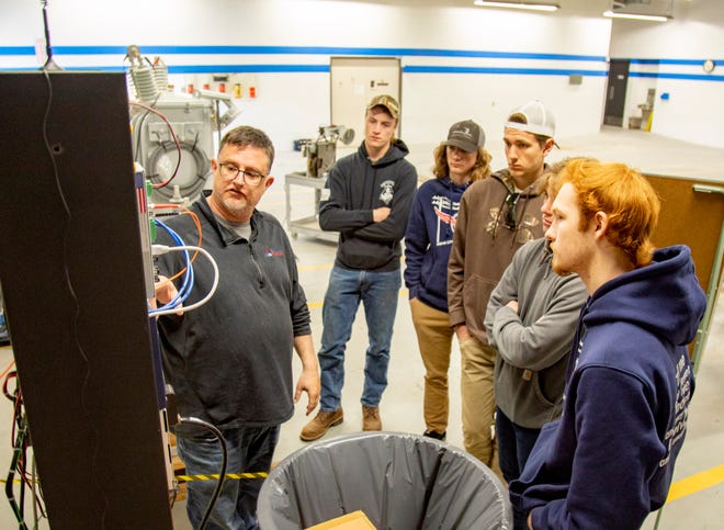 Dave Hickman, Crew Leader, Electrical Engineering III, guides students in the Char Em Energy Fundamentals Lineworker training program through supervisory control and data acquisition (SCADA) equipment demonstrations at Great Lakes Energy headquarters in Boyne City.