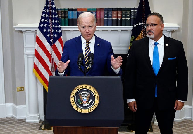 US President Joe Biden announces student loan relief with Education Secretary Miguel Cardona (right) on Aug. 24, 2022, in the Roosevelt Room of the White House in Washington, DC. - Biden announced that most US university graduates still trying to pay off student loans will get $10,000 of relief to address a decades-old headache of massive educational debt across the country. (Olivier Douliery/AFP via Getty Images/TNS)