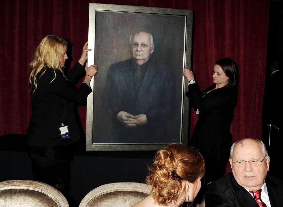Un portrait de Mikhaïl Gorbatchev est présenté à l'ancien dirigeant soviétique lors du gala Gorby 80 au Royal Albert Hall le 30 mars 2011 à Londres, en Angleterre.  Le concert a célébré le 80e anniversaire de l'ancien dirigeant soviétique.