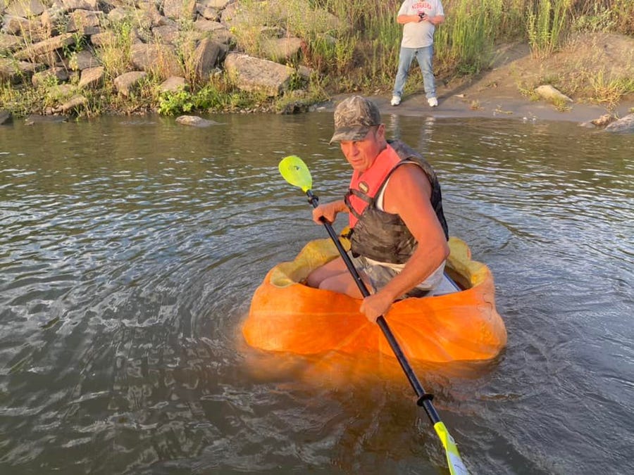 Duane Hansen paddled for 11 hours to set a world record floating inside of a pumpkin.