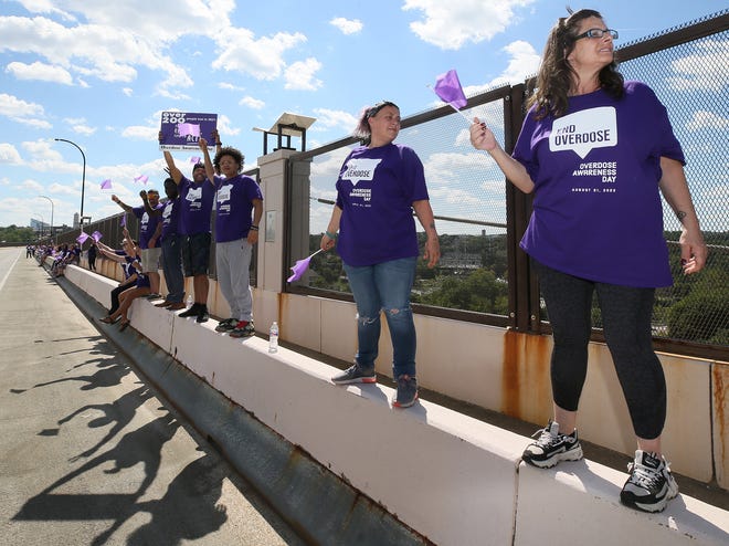 Participants join with the Summit Recovery Hub, Summit County Public Health and the Summit Opiate & Addiction Task Force to recognize Overdose Awareness Day on Wednesday along the All-America Bridge in Akron.