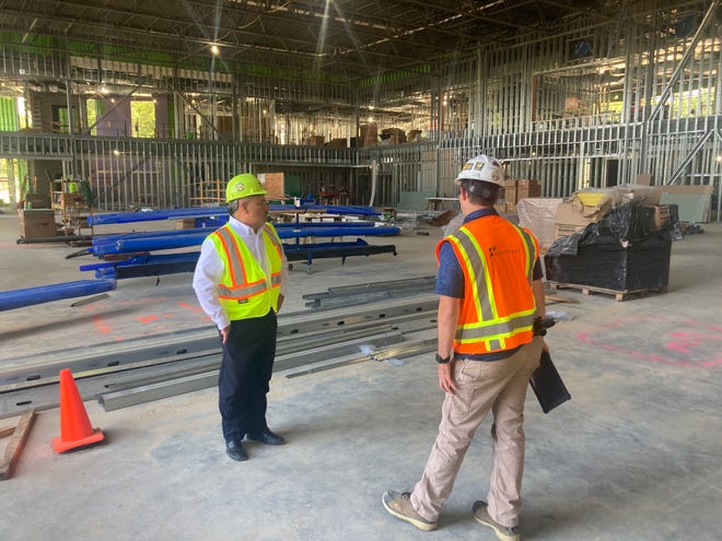 Ken Miller, at left, senior director for administration and student affairs at Penn State Behrend, discusses progress on the new $28.2 million Erie Hall with Shawn Turner, project manager for P.J. Dick.