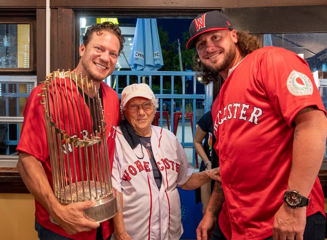 Former Red Sox stars Jake Peavy and Jarrod Saltalamacchia spend a moment with 93-year-old Nana Merlo of Sutton Tuesday night at Polar Park.