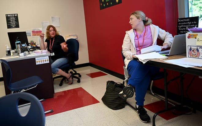 Nurses Caitlin Gilberg (right) and Olive Schultz discuss in the nurse's office at Marshall Simmons Middle School in Burlington on August 31, 2022.