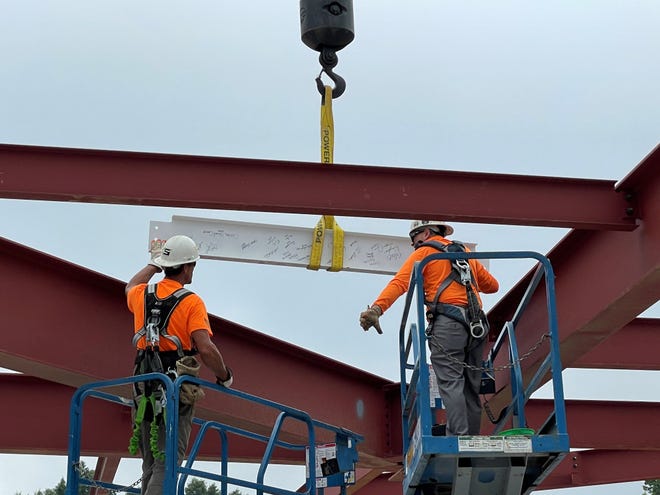 Workers install the final piece of steel for Bronson Behavioral Health Hospital on  Monday, Aug. 22, 2022 in Battle Creek, Mich. The 96-bed inpatient facility is expected to open in spring 2023.
