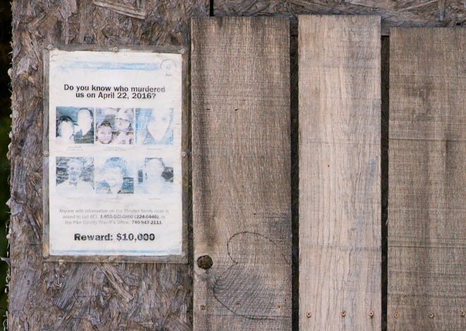 A faded reward poster hangs on a gray, wooden barn at 4077 Union Hill Road in Pike County, once the home of murder victim Christopher Rhoden Sr.  Jurors visited the site Aug. 31 for one of about a dozen "jury view" stops in the murder trial of George Wagner IV.
