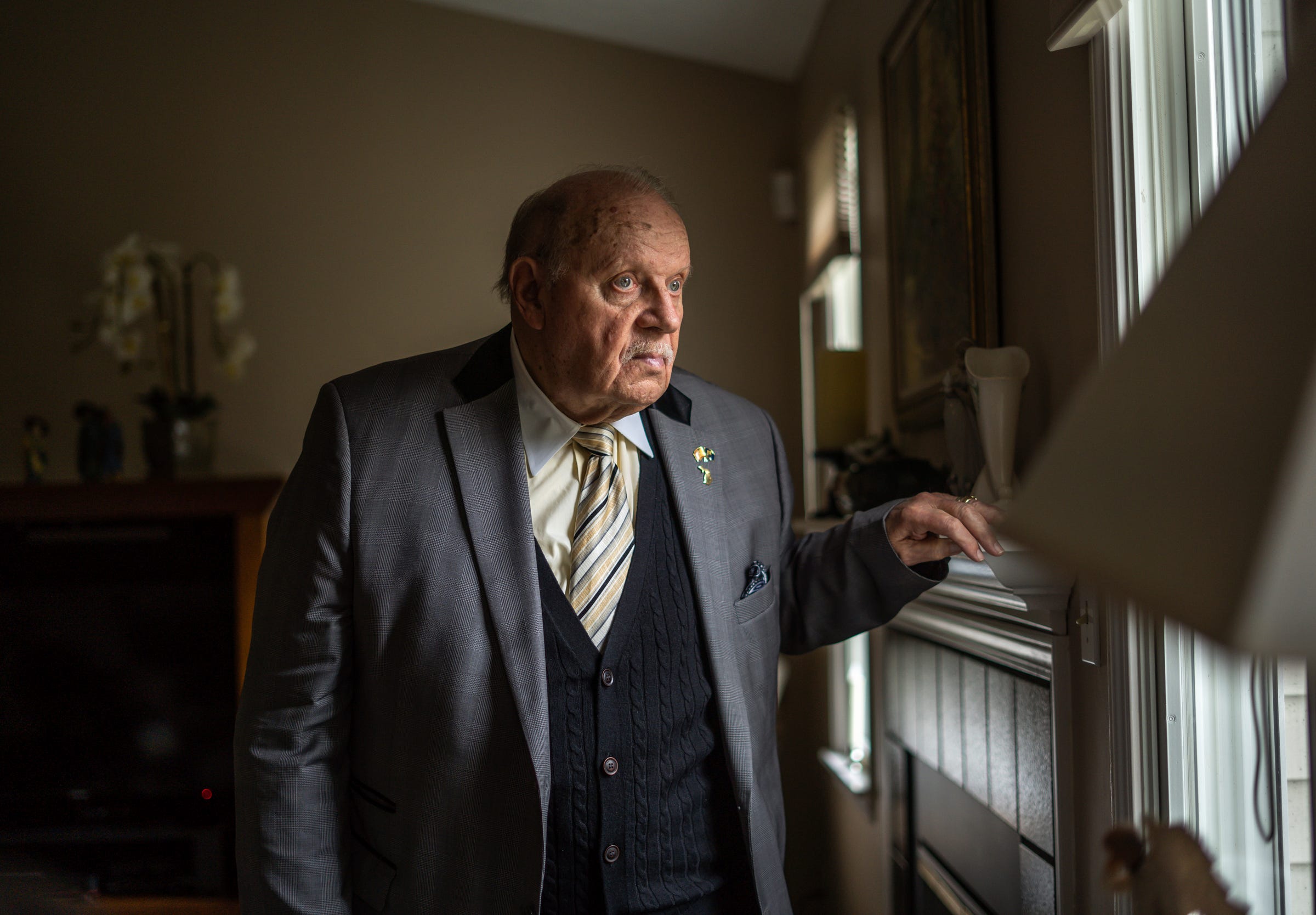 Paul Tarr, of Williamston, stands in his home on Friday, March 25, 2022. Tarr helped secure the rights of people with mental illness and developmental and intellectual disabilities in Michigan.