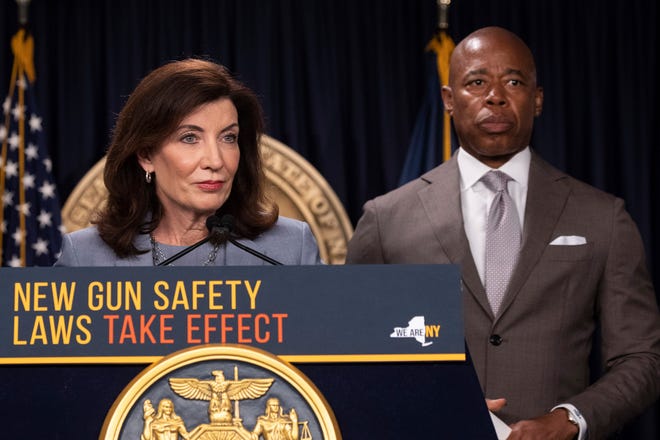 New York Governor Kathy Hochul, left, and New York City Mayor Eric Adams, right, attend a news conference about the state's new gun laws, most of which go into effect Sept. 1,  and the upcoming 