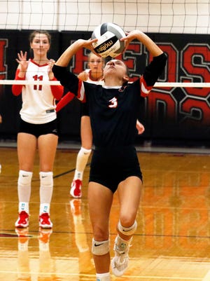 Lizzie Ellis sets the ball for New Lexington during its match on Tuesday at Coshocton. New Lex won, 25-18, 25-23, 25-16.