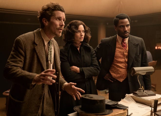 In the period mystery comedy "Amsterdam," Valerie (Margot Robbie, center) reunites with her friends, World War I veterans Burt (Christian Bale) and Harold (John David Washington) when they're accused of murder.