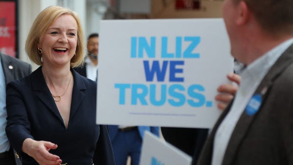 Liz Truss reacts as she is greeted by supporters u
