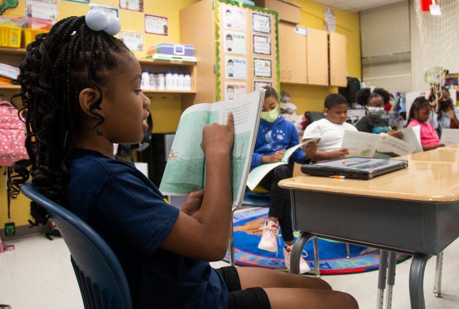 A third-grade student reads to the rest of her class at Beecher Hills Elementary School on Friday, Aug. 19, 2022, in Atlanta. Third-graders are at a particularly delicate moment. This is the year when they must master reading or risk school failure. Everything after third grade will require reading comprehension to learn math, social studies and science. Students who don't read fluently by the end of third grade are more likely to struggle in the future, and even drop out, studies show.   (AP Photo/Ron Harris) ORG XMIT: GARH107