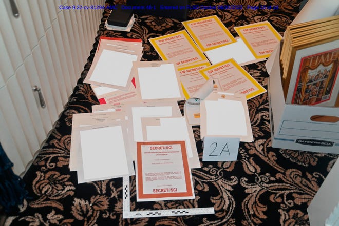 This image, contained in a court filing by the Department of Justice and redacted in part by the FBI, shows a photo of documents seized during the search on Aug. 8, by the FBI of former President Donald Trump's Mar-a-Lago estate in Florida.