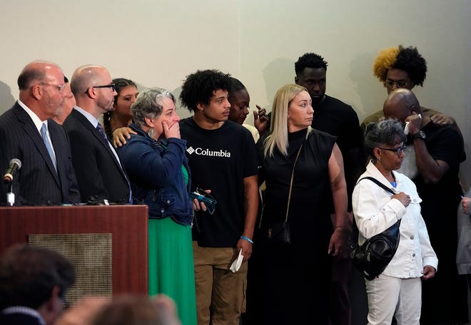 Friends and family of Donovan Lewis watch the police body camera video of the Tuesday shooting that took his life.