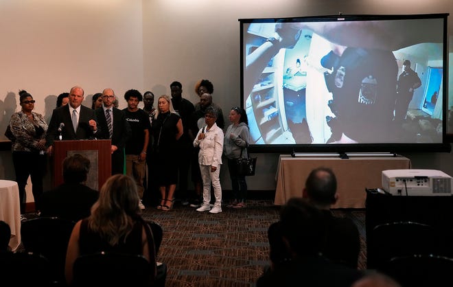 Lawyer Rex Elliott, surrounded by family and friends of Donovan Lewis, speaks during a Thursday press conference about the shooting by Columbus police that took Lewis' life on early Tuesday morning.