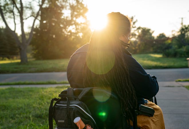 Jamie Junior, 46, a disability advocate, shares the transportation challenges she faces as a person using a wheelchair on Aug. 24, 2022, as she waits for a ride to work. Junior has to get up very early in order to secure a ride to work using paratransit services.