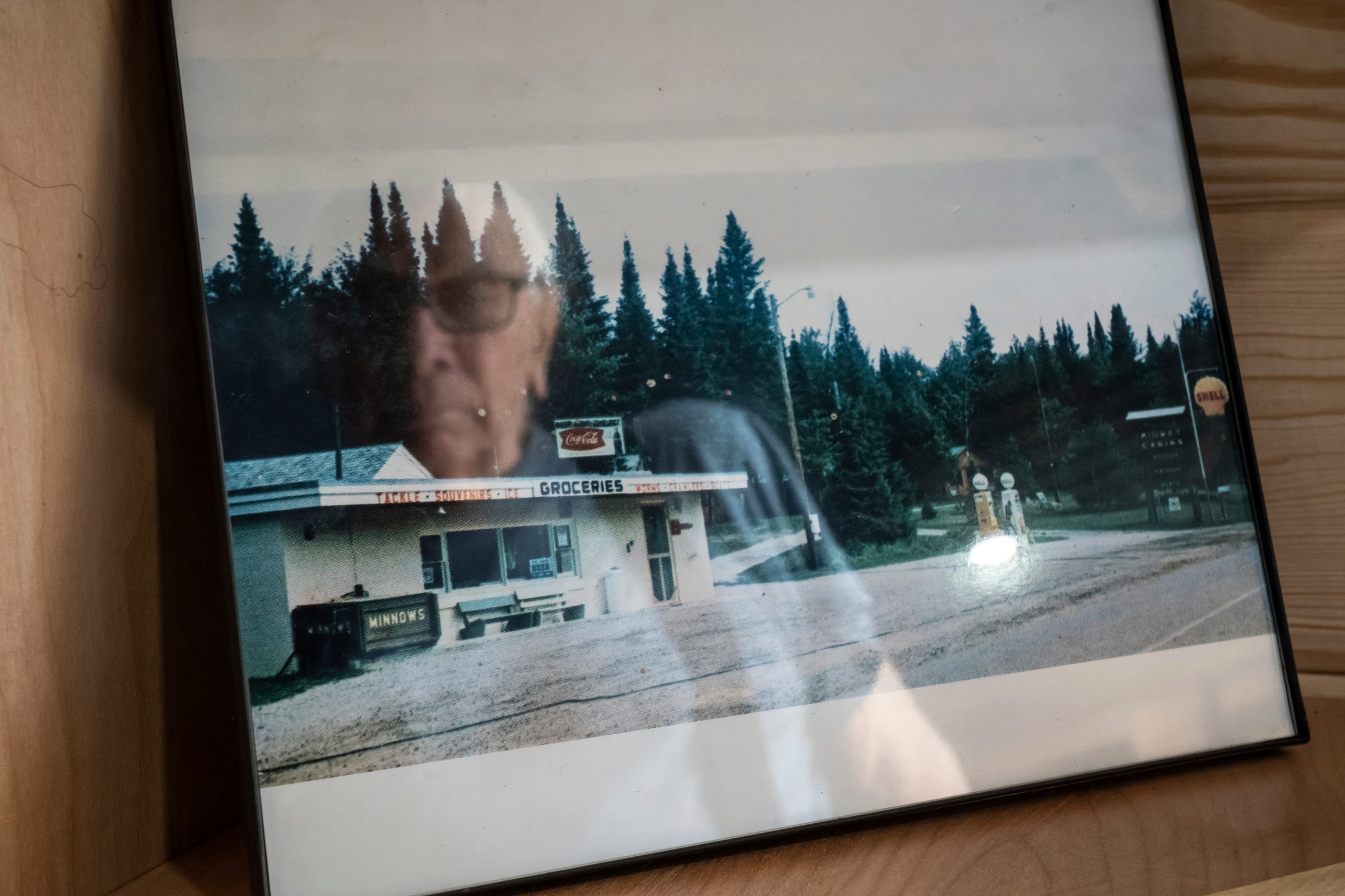 Mailman Ron Curtis, 86, of Wetmore looks at a photo of the Midway General Store he once owned and renovated as he visits the store, which is under new ownership, on Wednesday, July 27, 2022.