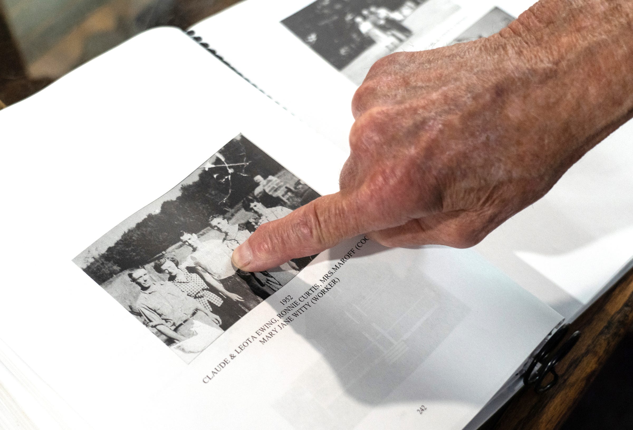 Mailman Ron Curtis, 86, of Wetmore points to a photo of himself in 1952 found in a local history book on display at the Midway General Store in Wetmore on Wednesday, July 27, 2022.
