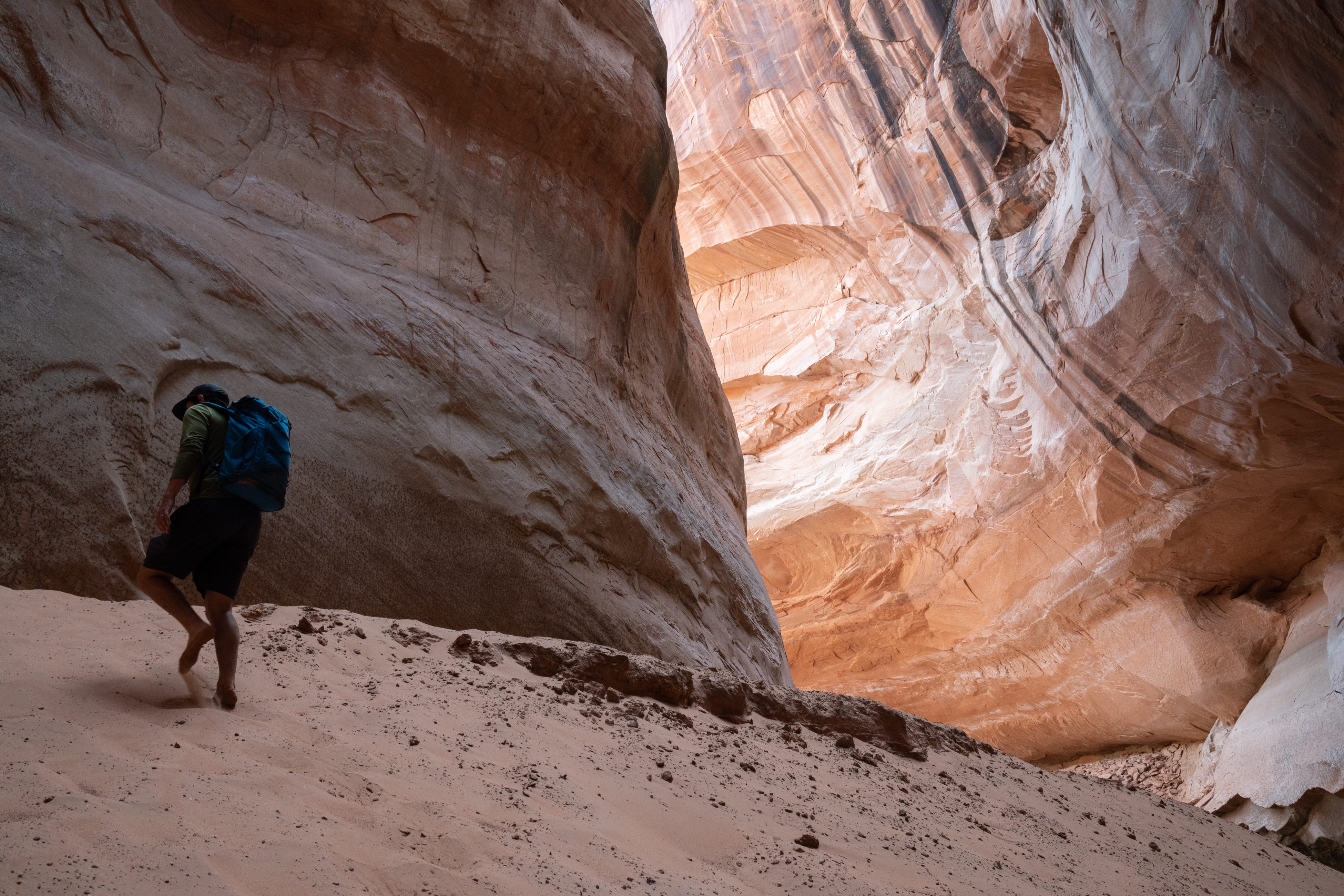 Eric Balken of the Glen Canyon Institute walks up a sediment deposit hill at Cathedral in the Desert on Aug. 15, 2022, at Lake Powell.